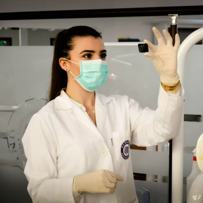 Krankenpflegerin schaut sich ein kleines Gerät an